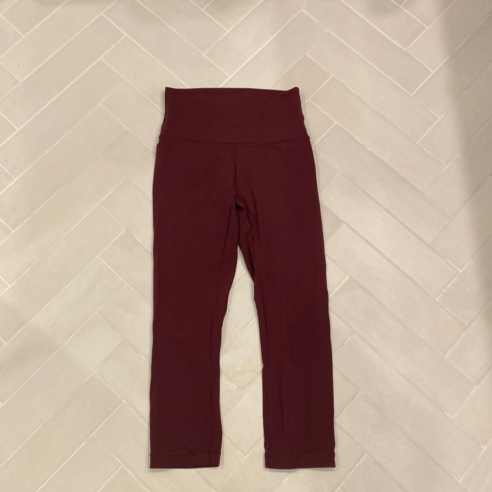 Women’s cropped burgundy lululemon leggings, size 4.